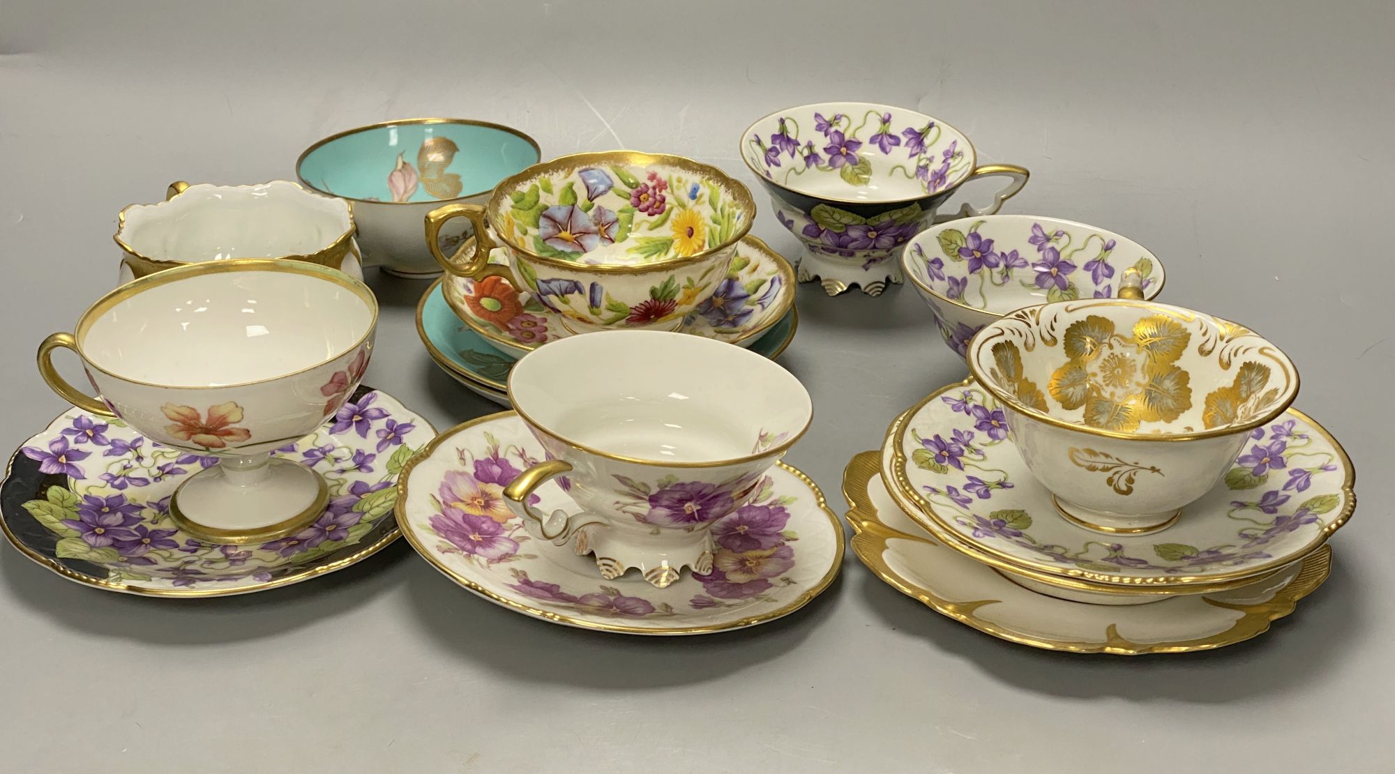 A collection of Continental porcelain tea cups and saucers